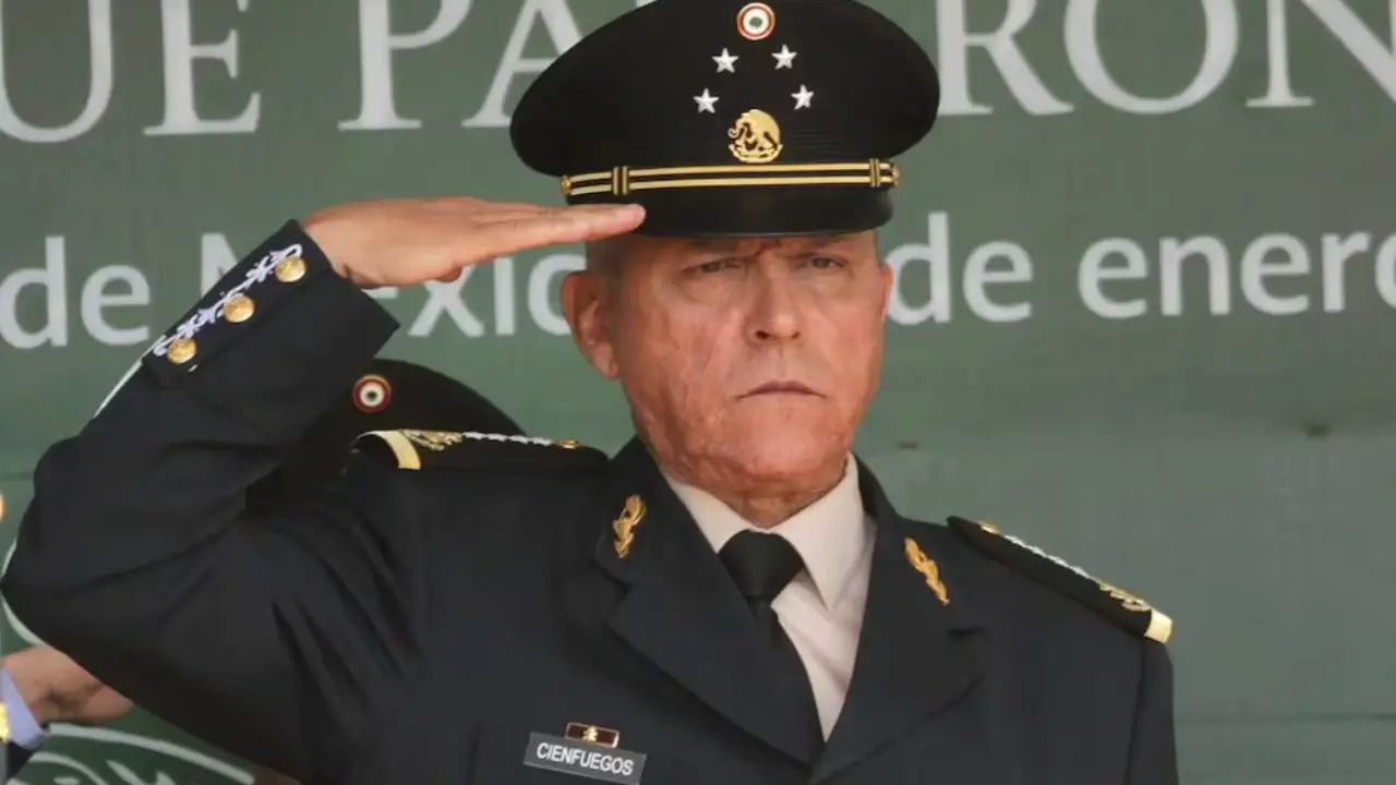Salvador Cienfuegos | México Ahora Senior military officer in dress uniform saluting with right hand outdoors badge reading CIENFUEGOS gold insignia on shoulders and cap