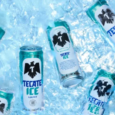 Tecate ICE Light innovación en frescura para cerveza light | México Ahora Several Tecate Ice cans chilling on a bed of crushed blue ice