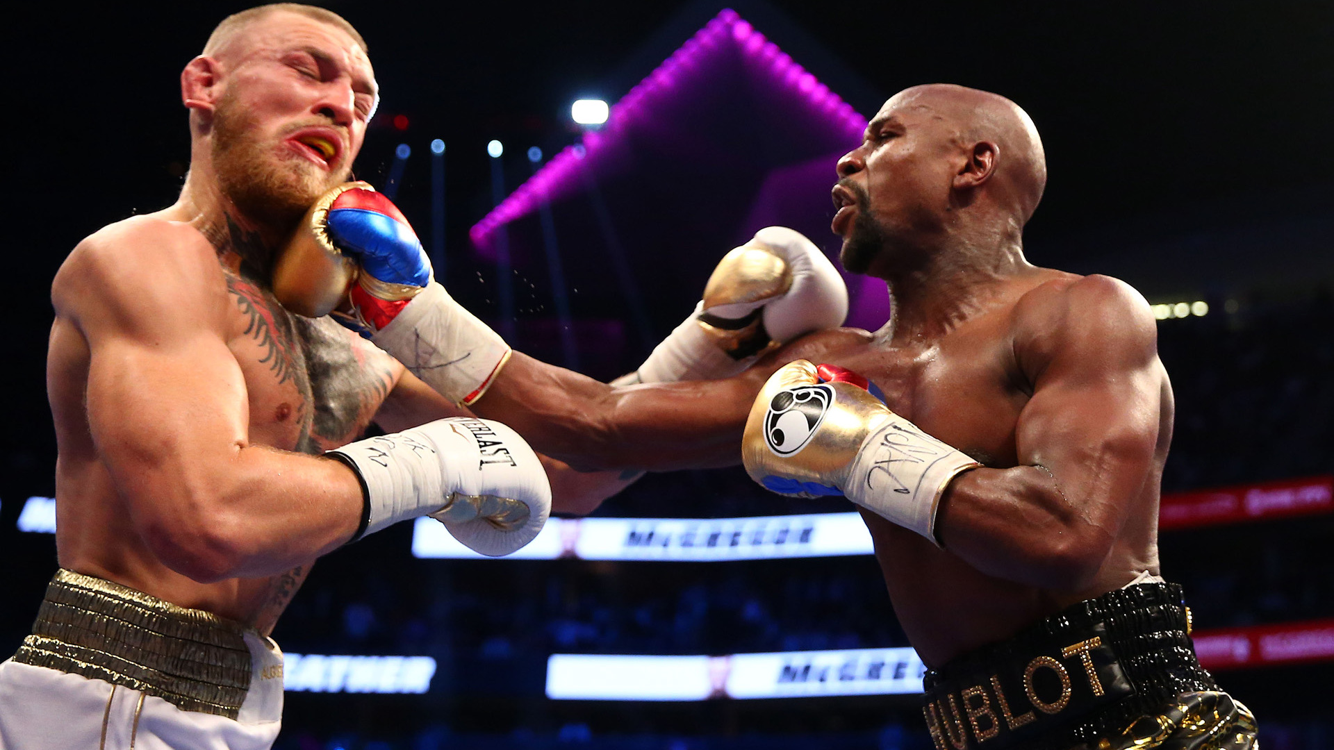 Aug 26, 2017; Las Vegas, NV, USA; Floyd Mayweather Jr. lands a hit against Conor McGregor during a boxing match at T-Mobile Arena. Mandatory Credit: Mark J. Rebilas-USA TODAY Sports