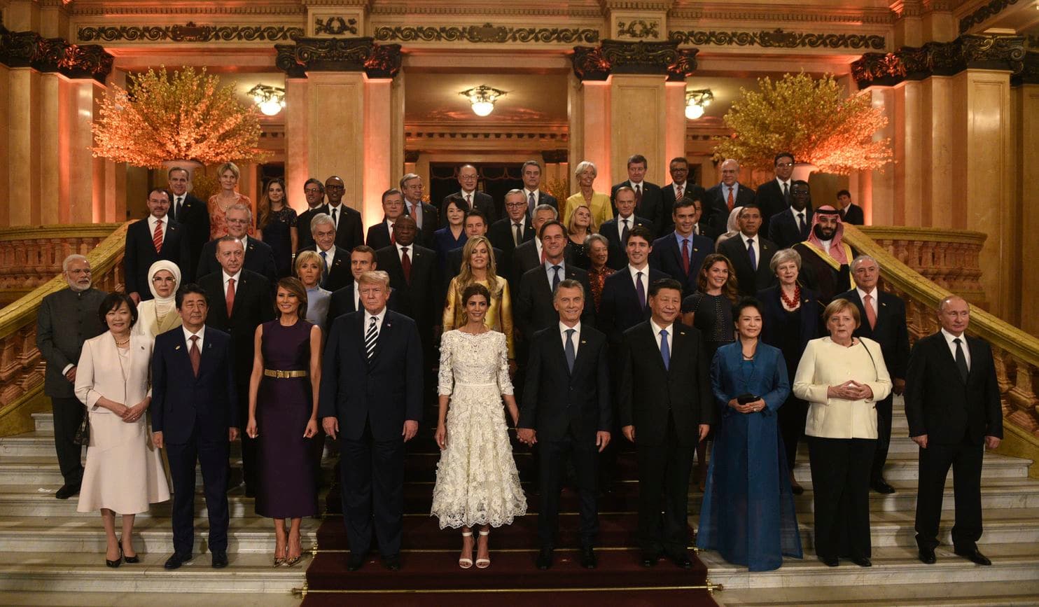 In this photo released by the press office of the G20 Summit, leaders and their partners pose for a group photo prior to a gala dinner at the Colon Theater in Buenos Aires, Argentina, Friday, Nov. 30, 2018. Leaders from the Group of 20 industrialized nations are meeting in Buenos Aires for two days starting today. (G20 Press Office via AP) (Associated Press)