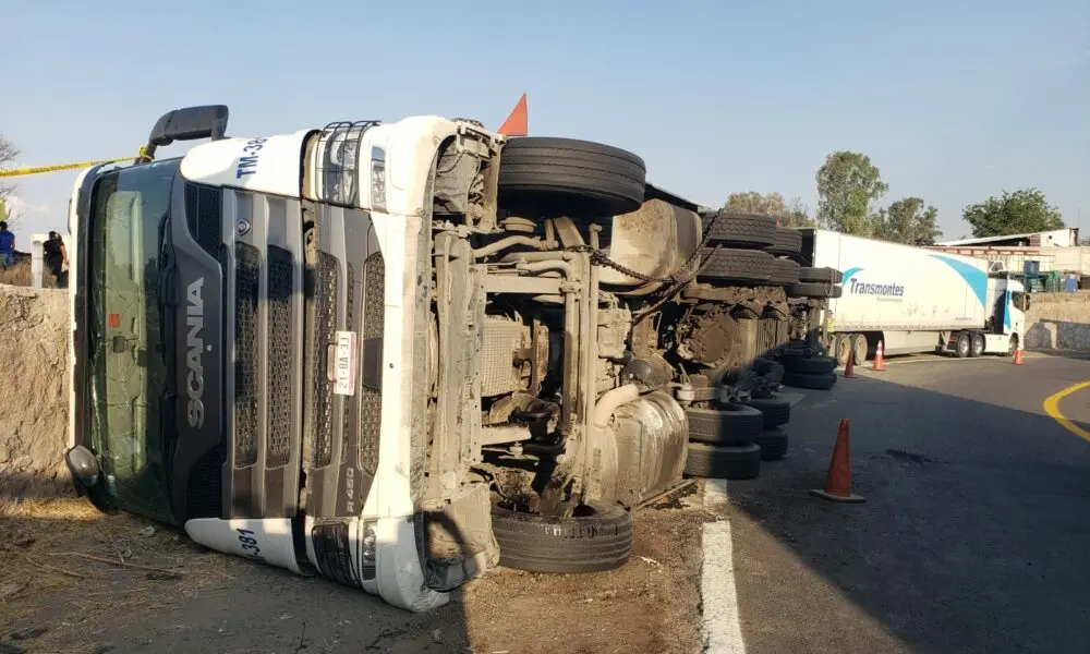 Tráiler vuelca y queda recargado contra barda de piedra   Noticias