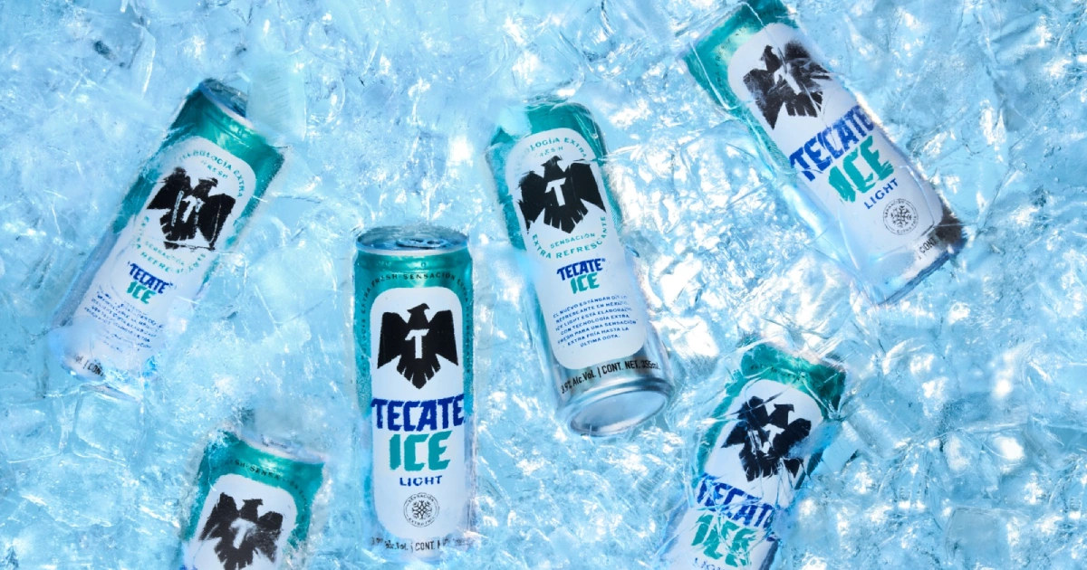 Several Tecate Ice cans chilling on a bed of crushed blue ice